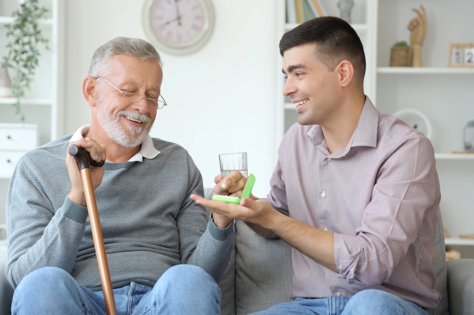 Caregiver assisting an elderly man with mobility support in his home in Keller, TX, fostering independence and safety.