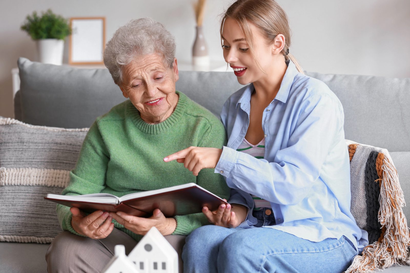 Caregiver assisting an elderly man in his cozy Keller, TX, home, providing compassionate senior home care services.